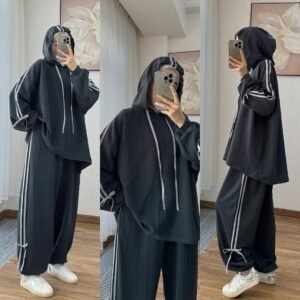 EaseFit Modest Tracksuit featuring a relaxed hooded top with white drawstrings and wide-leg trousers with side tie details, designed for modest comfort and sporty style, styled with a white inner hijab and sneakers in a soft indoor setting