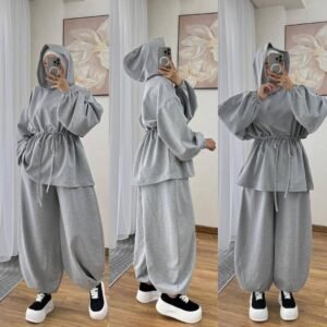 Modest two-piece women’s sporty outfit in many colors featuring a loose-fit hooded top with adjustable drawstring waist and wide-leg trousers, styled with an inner hijab cap