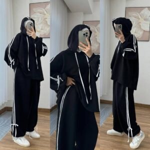 EaseFit Modest Tracksuit featuring a relaxed hooded top with white drawstrings and wide-leg trousers with side tie details, designed for modest comfort and sporty style, styled with a white inner hijab and sneakers in a soft indoor setting