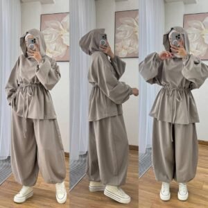 Modest two-piece women’s sporty outfit in many colors featuring a loose-fit hooded top with adjustable drawstring waist and wide-leg trousers, styled with an inner hijab cap