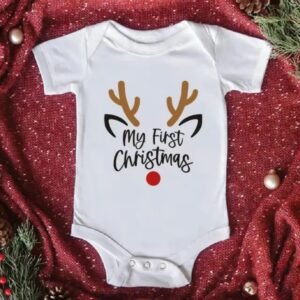 White baby romper with Santa Claus print and “Baby’s 1st Christmas” text — First Christmas Magic edition.