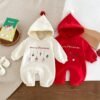 Baby Christmas romper with hoodie and red pom-pom, decorated with hanging festive icons including Santa, snowman, gift box, candy cane, and Christmas tree — “Festive Dangles” design.