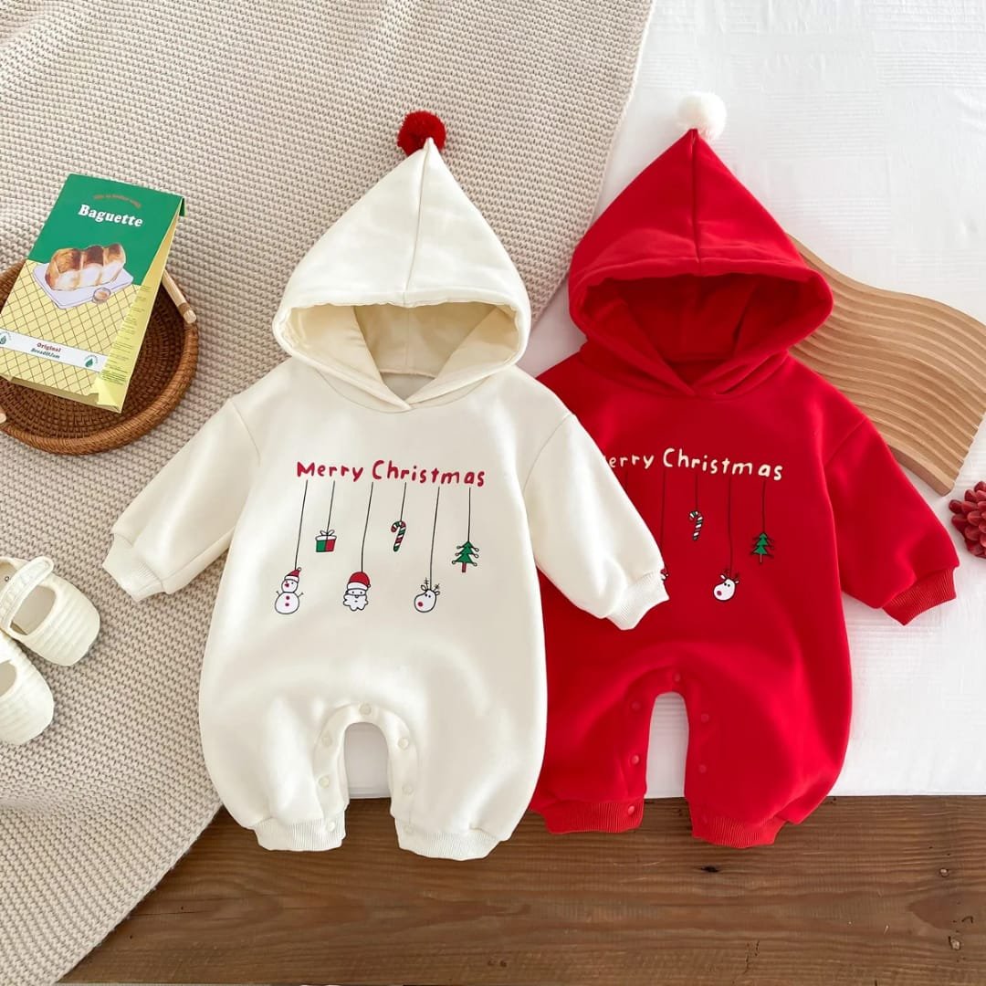 Baby Christmas romper with hoodie and red pom-pom, decorated with hanging festive icons including Santa, snowman, gift box, candy cane, and Christmas tree — “Festive Dangles” design.
