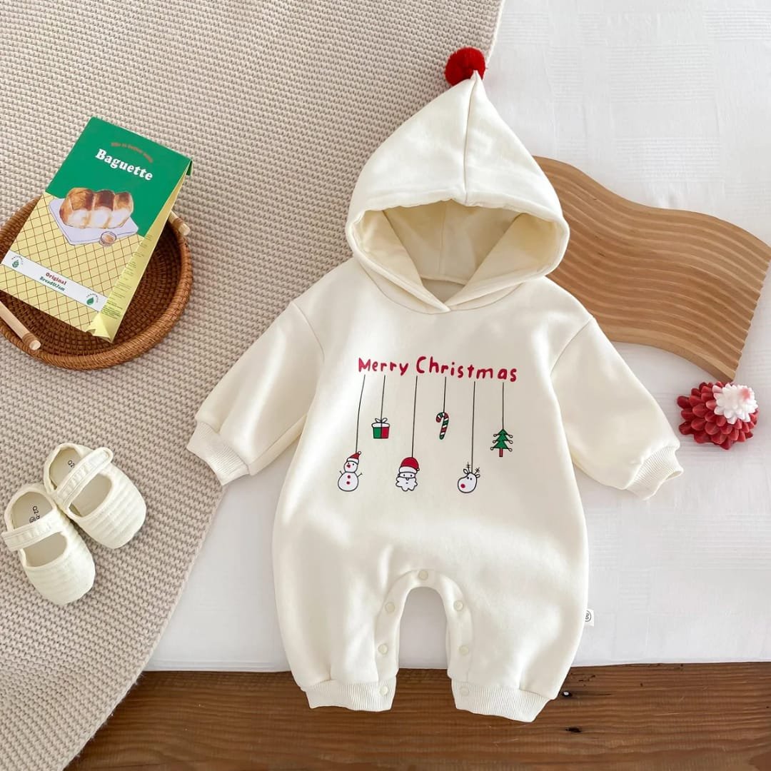 Baby Christmas romper with hoodie and red pom-pom, decorated with hanging festive icons including Santa, snowman, gift box, candy cane, and Christmas tree — “Festive Dangles” design.