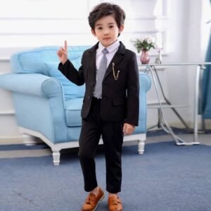 Young boy wearing a formal boys’ suit set with blazer, trousers, white shirt, and tie — Little Gentleman Set.