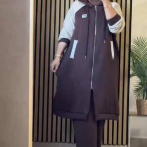 A modest two-piece outfit featuring a long zip-front hoodie jacket with contrast sleeves and wide-leg trousers. Designed for flexibility, layering, and effortless modest style.