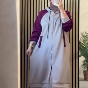 A modest two-piece outfit featuring a long zip-front hoodie jacket with contrast sleeves and wide-leg trousers. Designed for flexibility, layering, and effortless modest style.